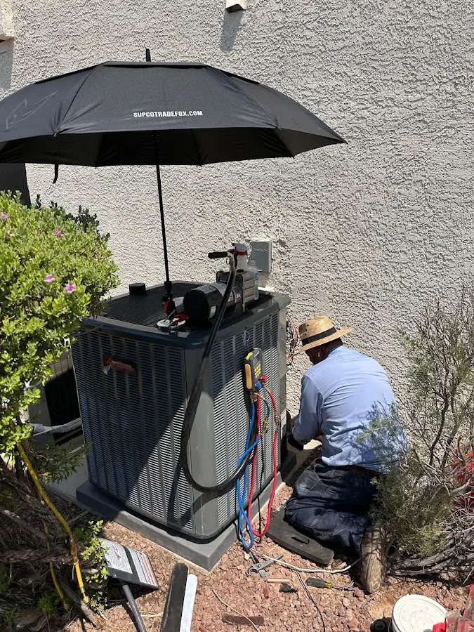 HVAC technician performing outdoor AC maintenance in Florence